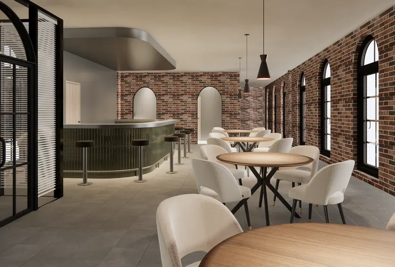 Café looking east, with brick walls, arched windows and a curved green bar.